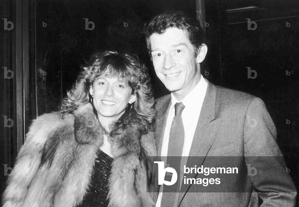 John Hurt British film actor and wife at airport in February 1985 (b/w photo)