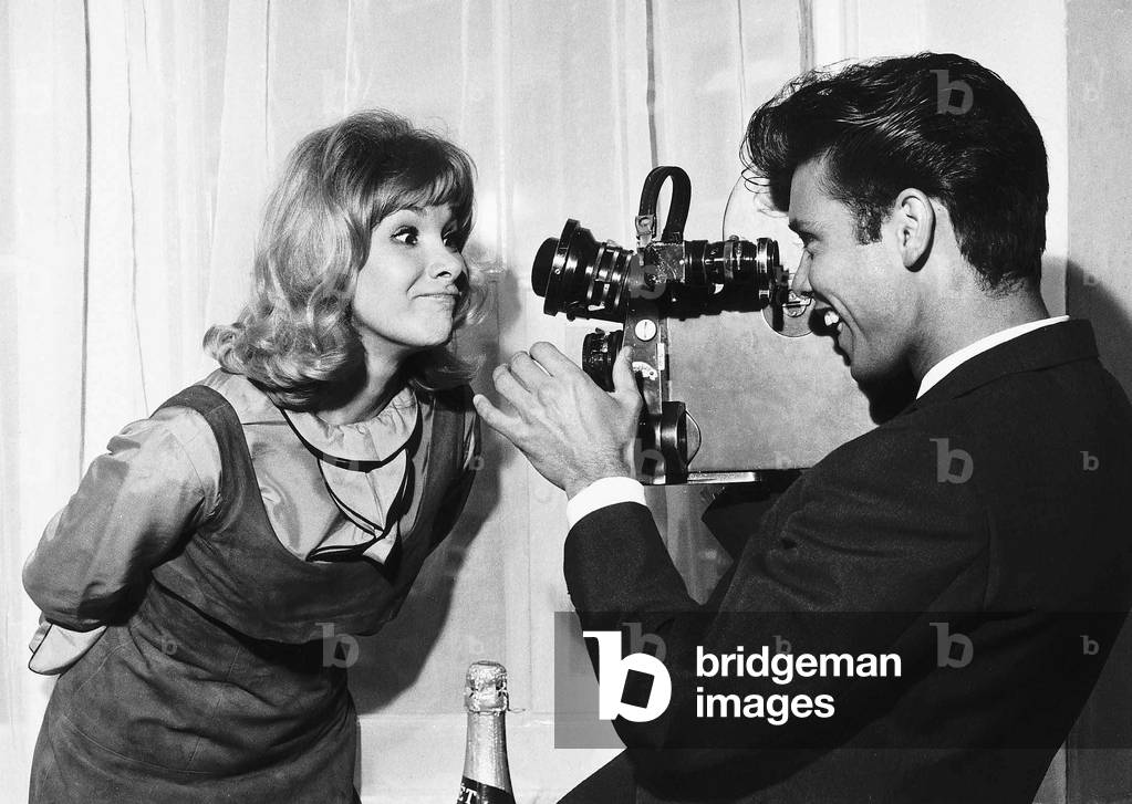 Cliff Richard Singer Actor gets behind the camera to film his co star, pulling a funny face. 1963
