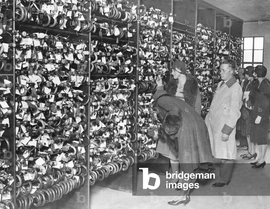 Ladies trying to find their umbrellas in the London Transport Lost Property Office, Lambeth. All these umbrellas were lost just in April. 27th May 1929