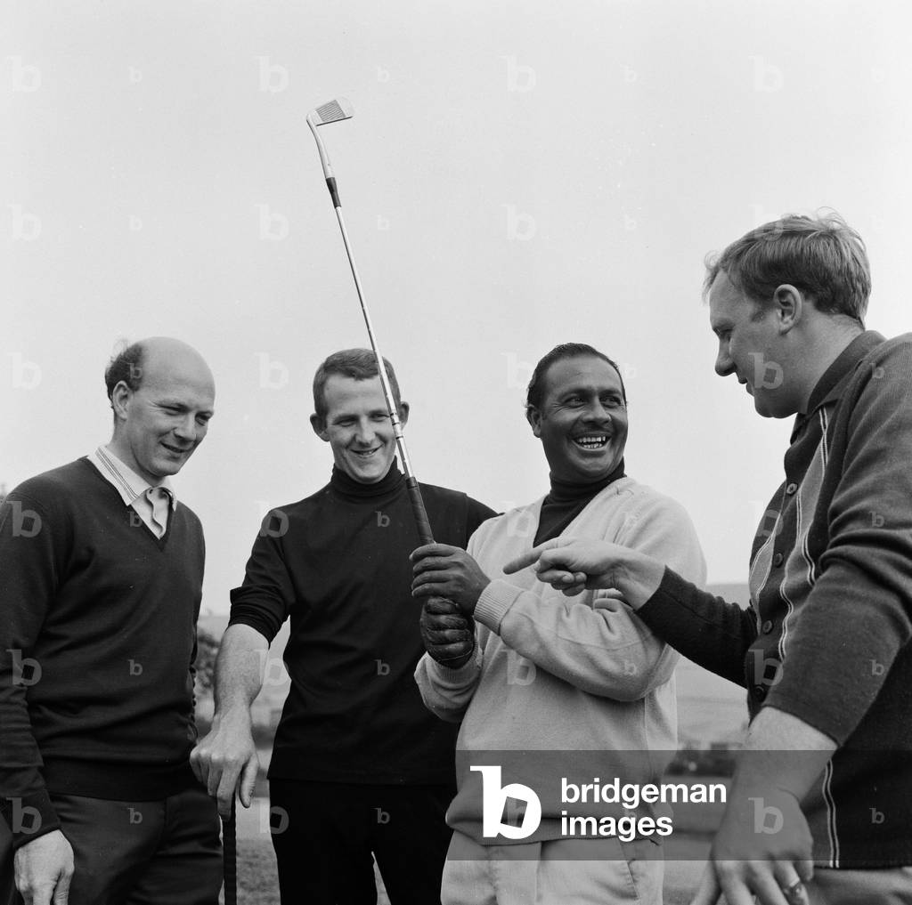 South African golfer Sewsunker Sewgolum at Stalybridge Stamford golf club where he participated in an invitation match against two of the clubs top players Barry Sidebottom (second left) and Colin C Gill in preparation for the upcoming British Open. Partnering Swegolum was Mike Hoyle. 14th July 1967 (b/w photo)