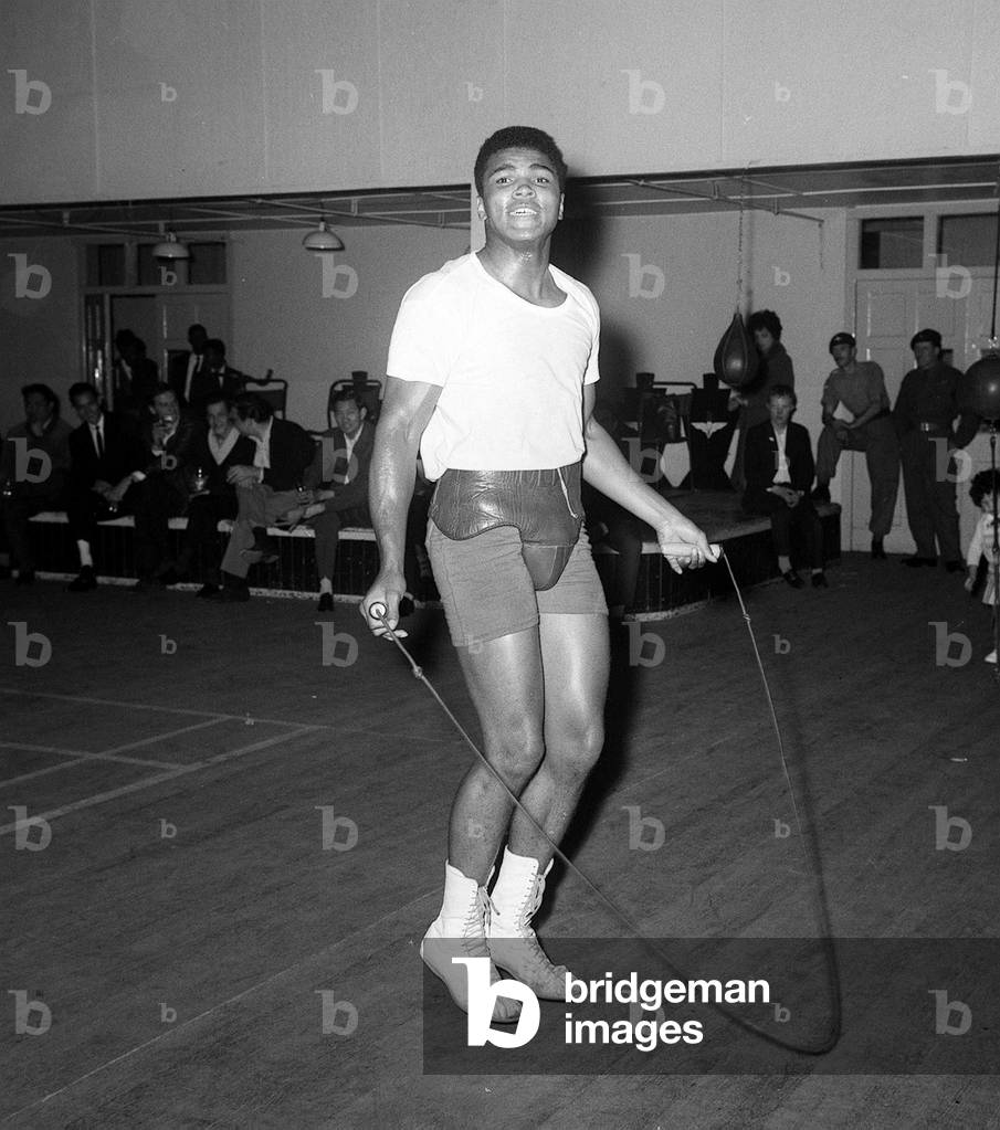 Muhammad Ali use a skipping rope during training before his fight with Henry Cooper, June 1963 (b/w photo)