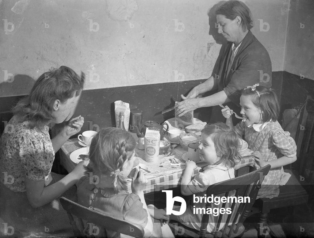 Tea time. The family gather around the kitchen table for a tea time meal, September 1946