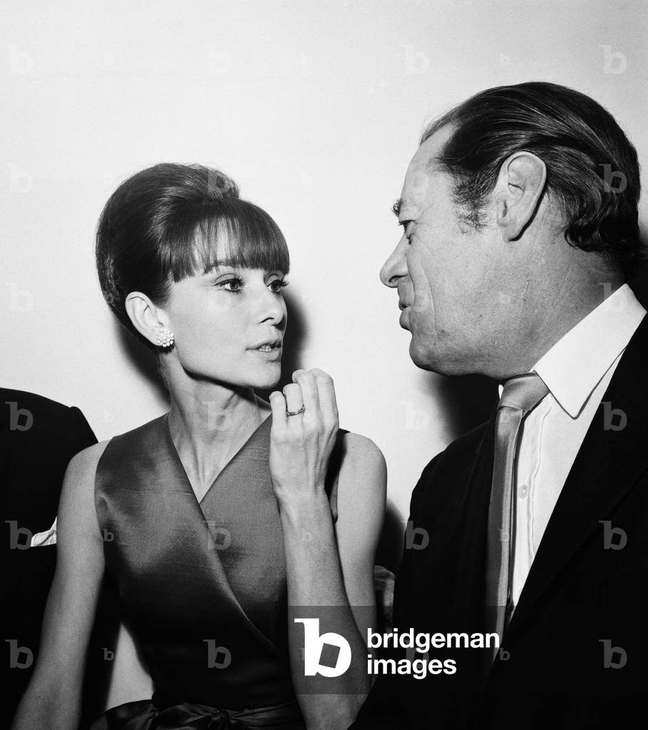 Actress Audrey Hepburn pictured with Rex Harrison at a press reception at the Savoy Hotel in London, held for some of the stars of the film 