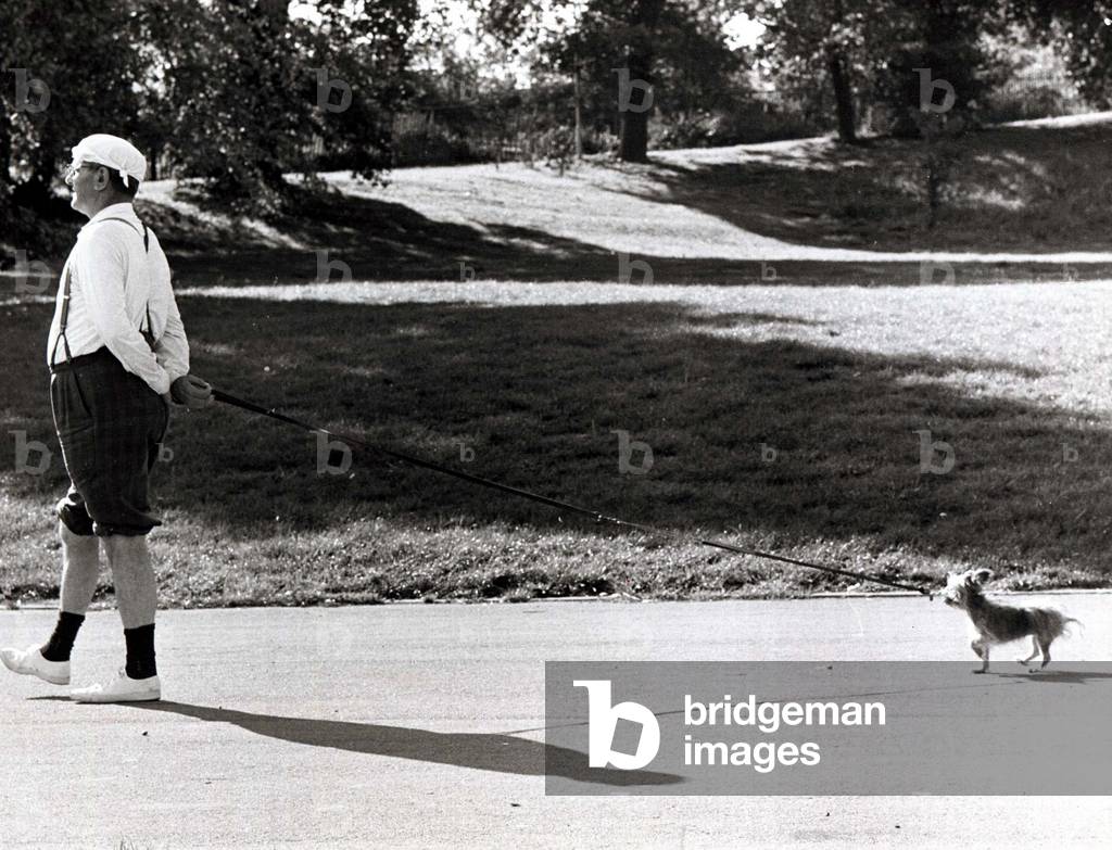 Ernest Heaton is shown here with his dog Pip during a sponsored stroll for charity at Crystal Palace in London with 50 dog owners. Pip obviously found his walk-on part a bit of a drag. September 1976 (b/w photo)
