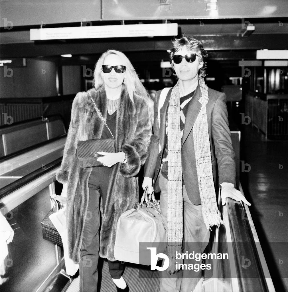 Rolling Stones. Mick Jagger and Jerry Hall leaving London Airport Heathrow for a Christmas Holiday in Barbados. 19 December 1982