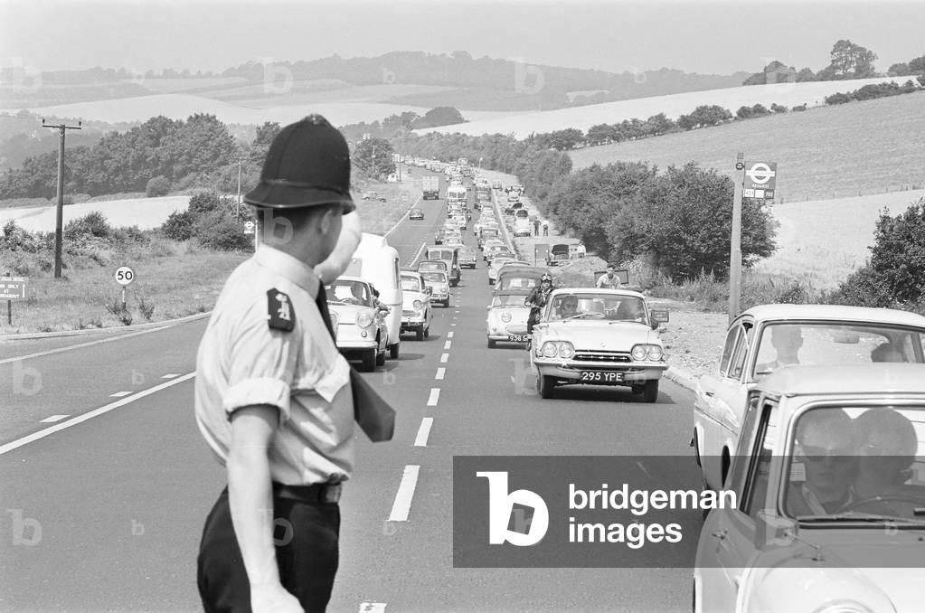 Policeman directing August Bank Holiday traffic on the A20. 3rd August 1964 (b/w photo)