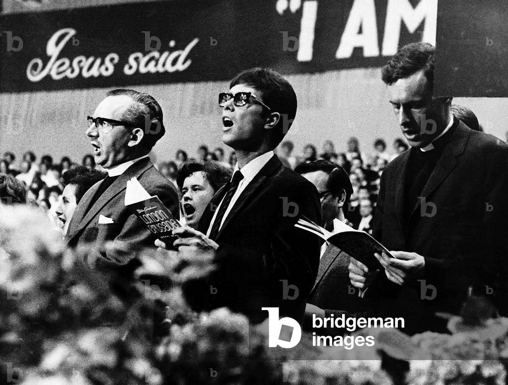Cliff Richard sings for Billy Graham at a Christian rally in Earl's Court. 1966