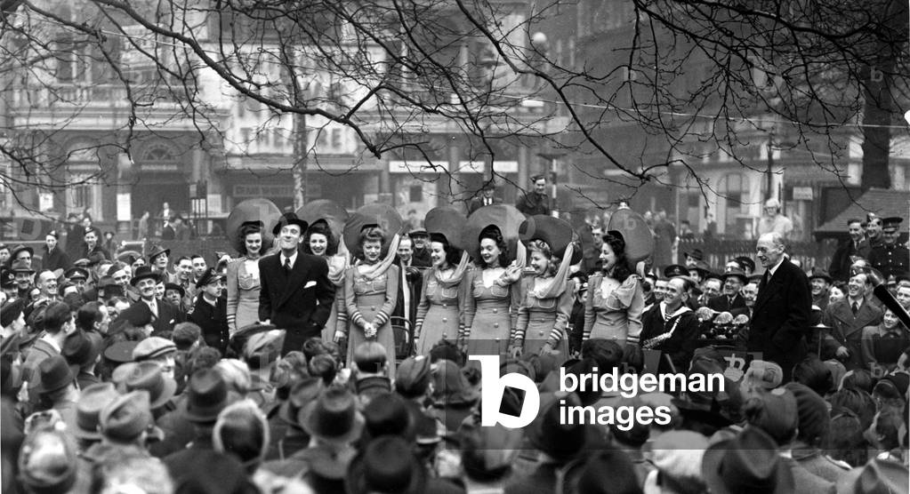 Wings for Victory week. Tommy Trinden and the girls do an open air turn in Leicester Square in aid of Wings for Victory week, March 5th 1943 (b/w photo)