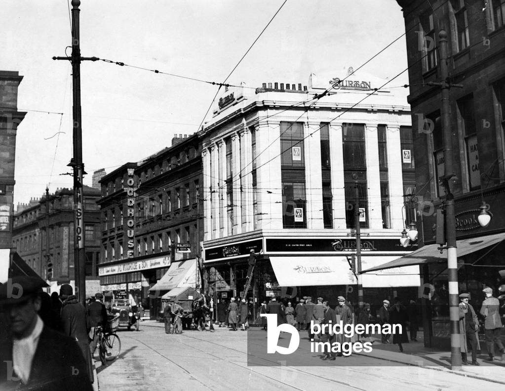 A horse pulls a small cart and an open top car travels up Newgate Street to the corner of Clayton Street in Newcastle, April 1930 (b/w photo)
