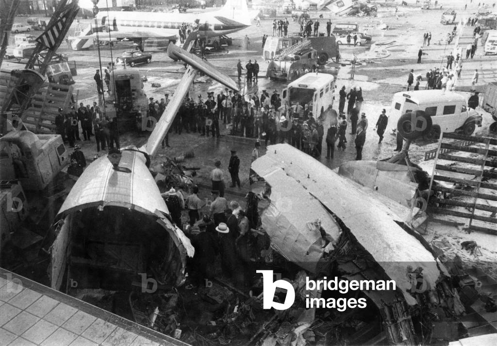 Rescuers ring the wrecked Elizabethan pictured after the crash at London Airport on Wednesday night (3-7-68), July 1968
