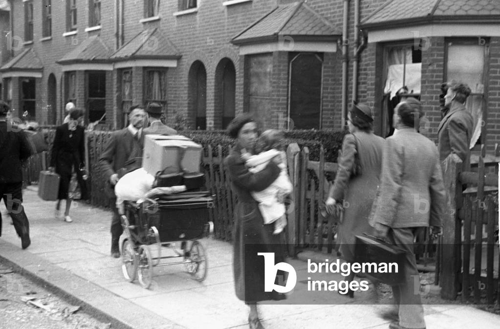 Alfieri. Air Raid damage at Malden, London. Residents walk down the street past damaged houses, August 16th 1940