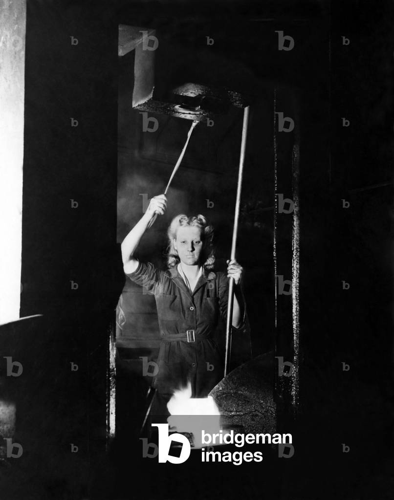 World War II Women. A woman operating a power hammer at the L.N.E.R. loco works. May 1942