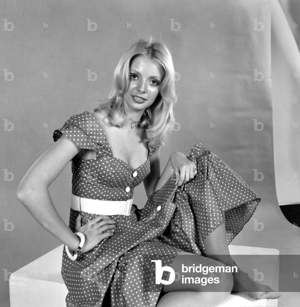 German glamour model Maureen wearing a short sleeved patterned summer dress, April 1975 (b/w photo)