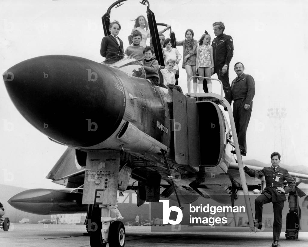 Children of pilots from 43 Squadron, the Fighting Cocks, pose for photographs on a phantom at Leuchars in Fife, August 1970 (b/w photo)