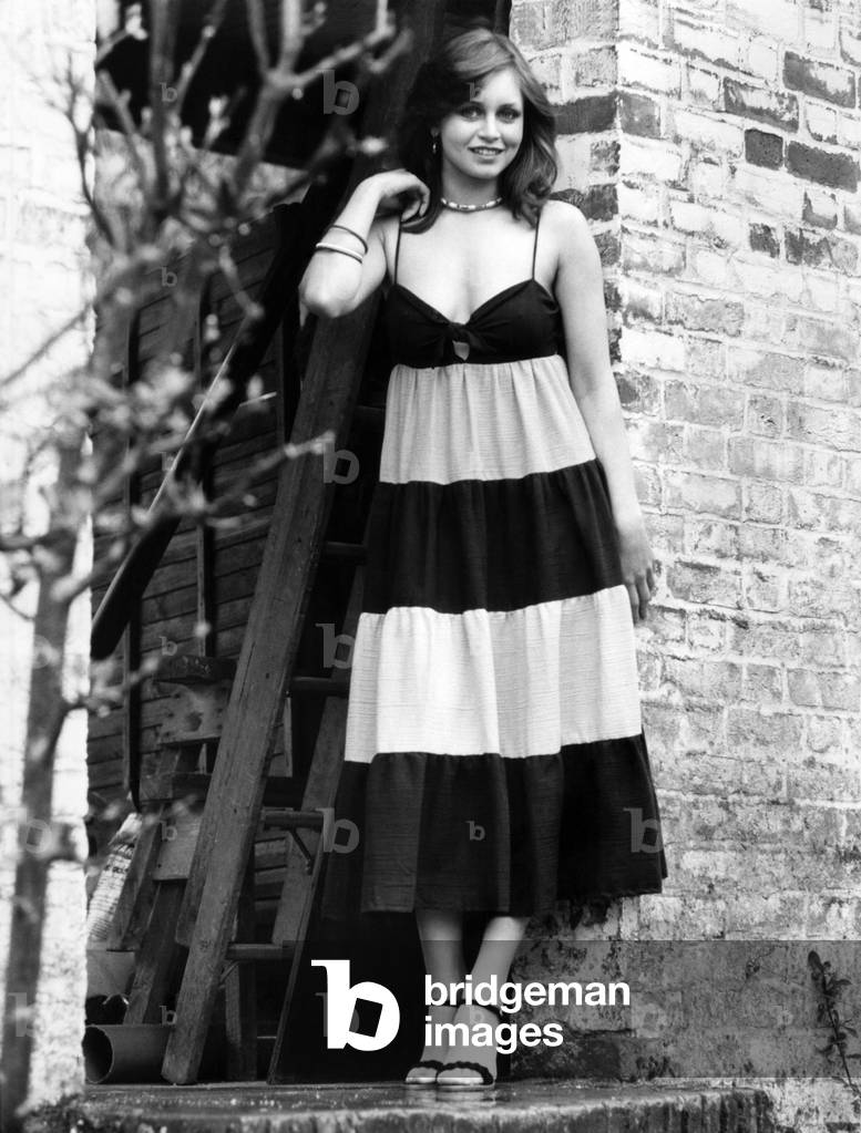 Striped black and pink sundress also available in black or white with assorted colours, in sizes 8-16. It costs £11.95 from main branches of Wallis. Black Suede Shoes, £11.99, Ravel. June 1977