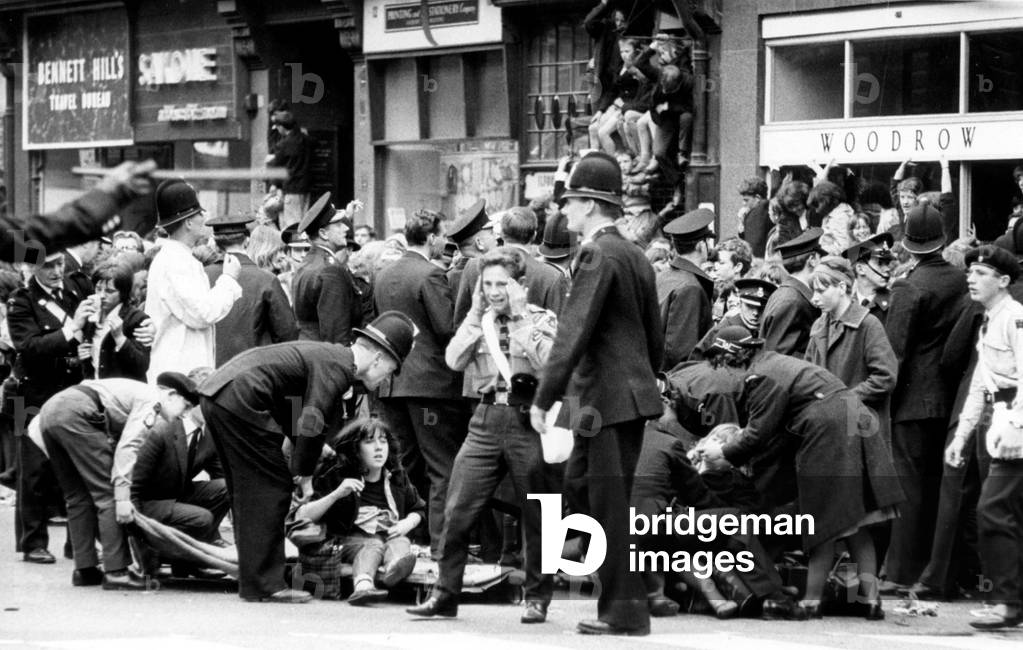 The Beatles in Liverpool, Friday 10th July 1964. Back home for evening premiere of 'A Hard Day's Night' at the Odeon Cinema. Pictured, fans feeling faint outside Town Hall.