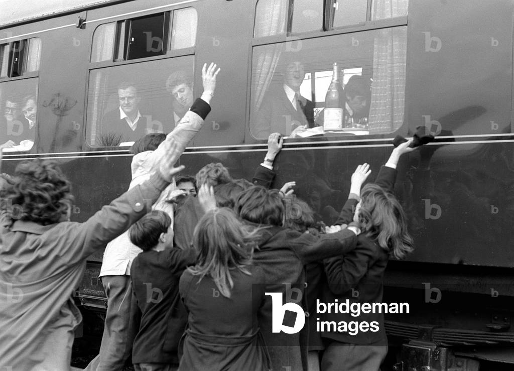The Beatles March 1964
Crowds of school children wave to the Beatles sitting on a train on location for filming 