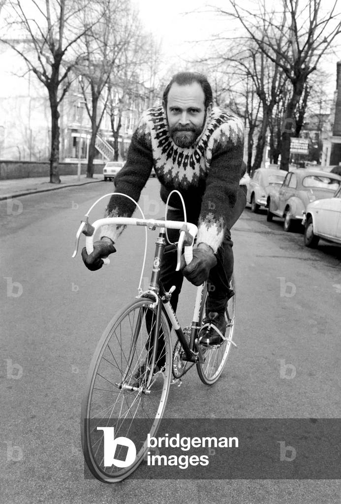 Cycling journalist and writer Mr. Richard Ballantine riding a bicycle, 19th February 1975