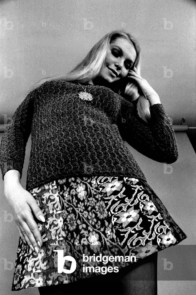 A model wears a jumper and skirt during a fashion shoot, 13 April 1970 (b/w photo)