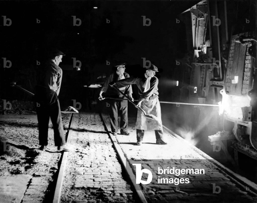 World War Two - Second World War - Steel workers tend to the furnaces keeping up vital war production of the metal. 01/07/1940 (b/w photo)