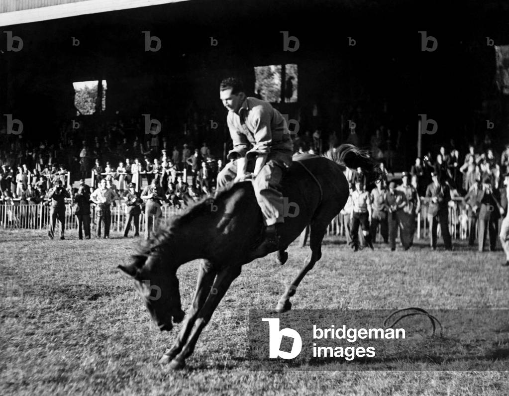 Lonny Harvard (Texas) air gunner, with the USAAF. He was over Germany earlier today and now is competing at Rodeo this evening. August 1944