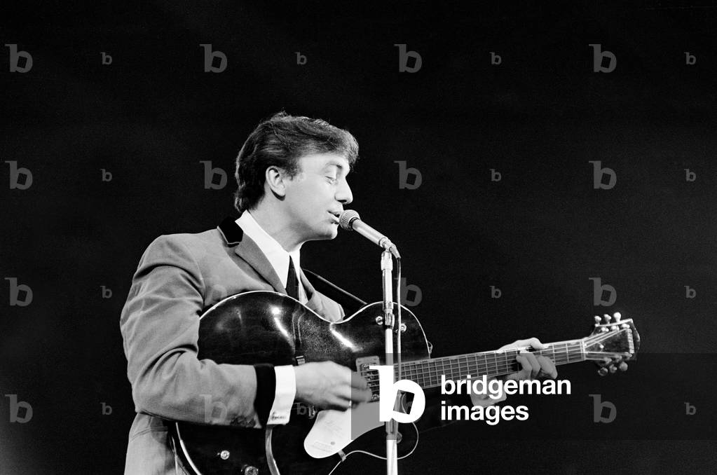 Gerry Marsden, lead singer of Liverpudlian pop group Gerry and the Pacemakers performing on stage at the annual IPC New Musical Express pop concert at Empire Pool, Wembley. 26th April 1964 (b/w photo)
