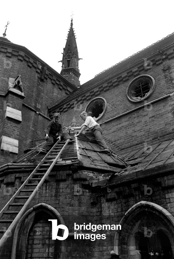 Reverend Vivian Symons helps to demolish All Saints church in Peckham for Re-Erection at Biggin Hill. 
August 1952 
C3961-001