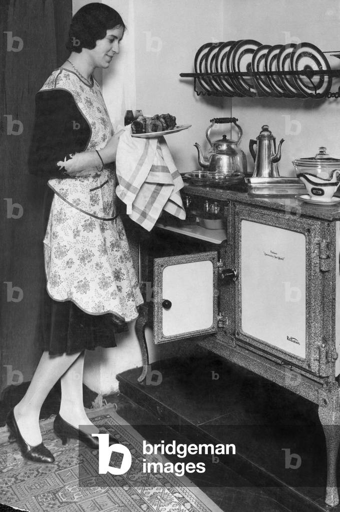 Housewife with her new Flecthers Queensday New World gas regulator oven and hob. 19th April 1930