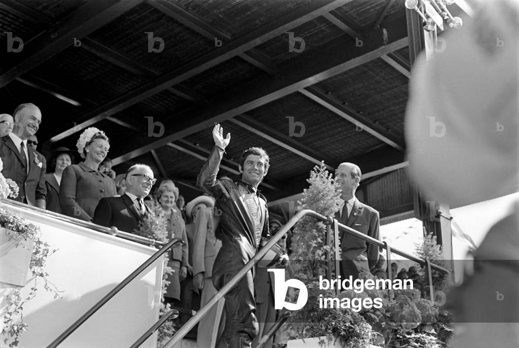 Sport Motorcycling: Isle of Man TT Racing 350 CC Class Junior. Giacomo Agostini waves from the podium as he celebrates victory. June 1969