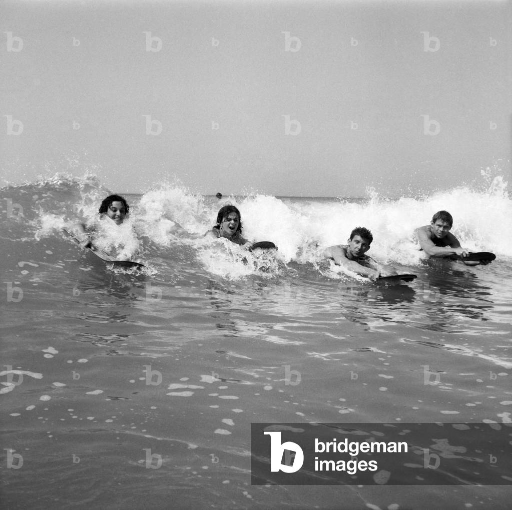 Women body boarding in the surf at Newquay June 1960