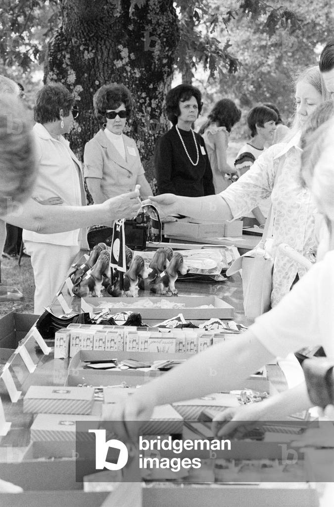 Elvis Presley Fans from Britain, Holland and Denmark browse and buy souvenirs during visit to his house and birthplace in Tupelo, Lee County, Mississippi, USA, 27th August 1973 (b/w photo)