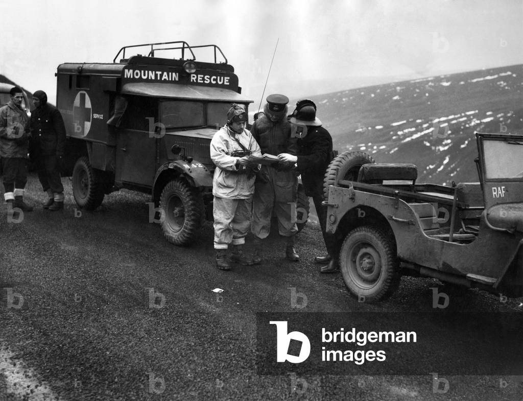 Harpur Hill Buxton RAF Rescue team at work. L to R Lac Austin, walkie talk operator F1/Lt Allan, officer in charge and Station Officer R.J. Cox o Buxton mark spot of supposed crash. January 1949