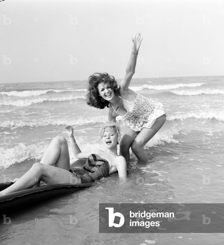 Beach Glamour: Having holiday fun in the sun at Minnis Bay near Margate, Kent. are girl with dark hair (A red head) Beverley Bennett age 18 and Blonde Ingrid Young age 16 both girls are actresses at the Adia Foster School. June 1960