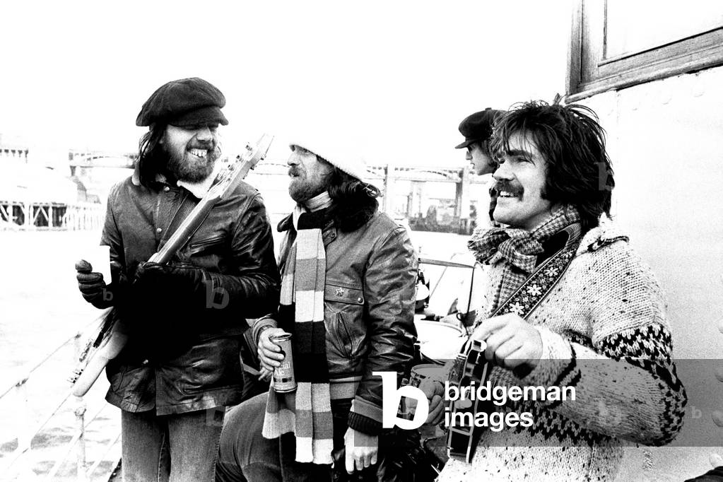 Lindisfarne sailed down the Tyne on a musical journey. The group were filming on board a Tyne ferry for a half-hour television show called 'All Right Now'. Rod Clements, Si Cowe and Ray Jackson pictured. 4th March, 1979 (b/w photo)