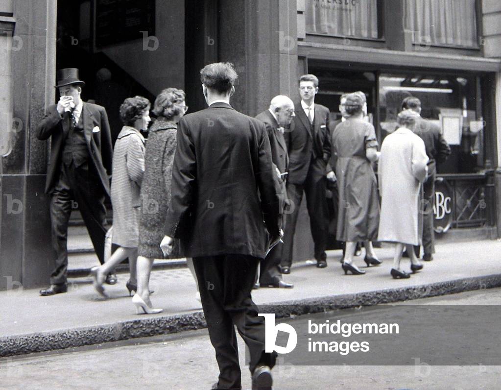 A betting shop situated in the City, London which prefers not to do business in cash, May 1961 (b/w photo)