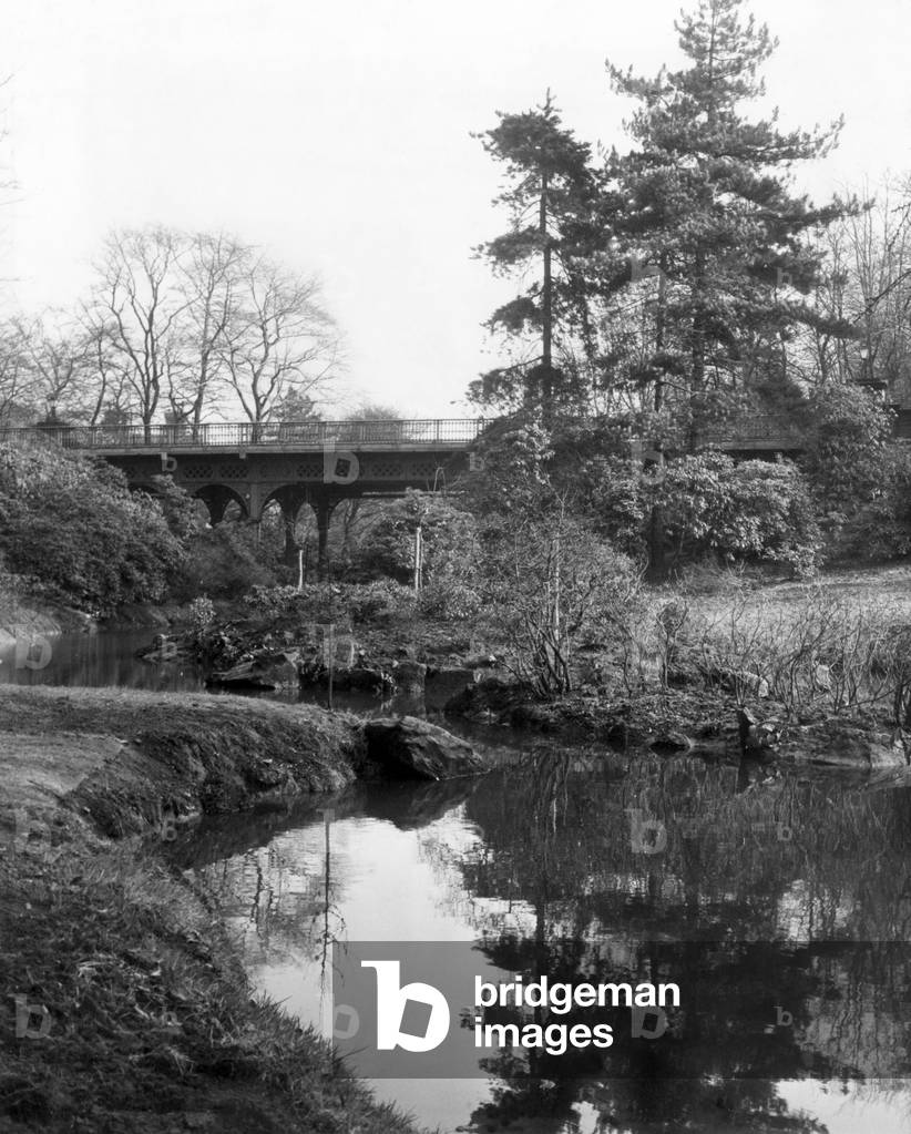 Sefton Park, Liverpool, Merseyside, a 235 acre park, opened to the public in 1872. Sefton Park's iron bridge over muddied water, before the vandals moved in, 6th March 1969 (b/w photo)