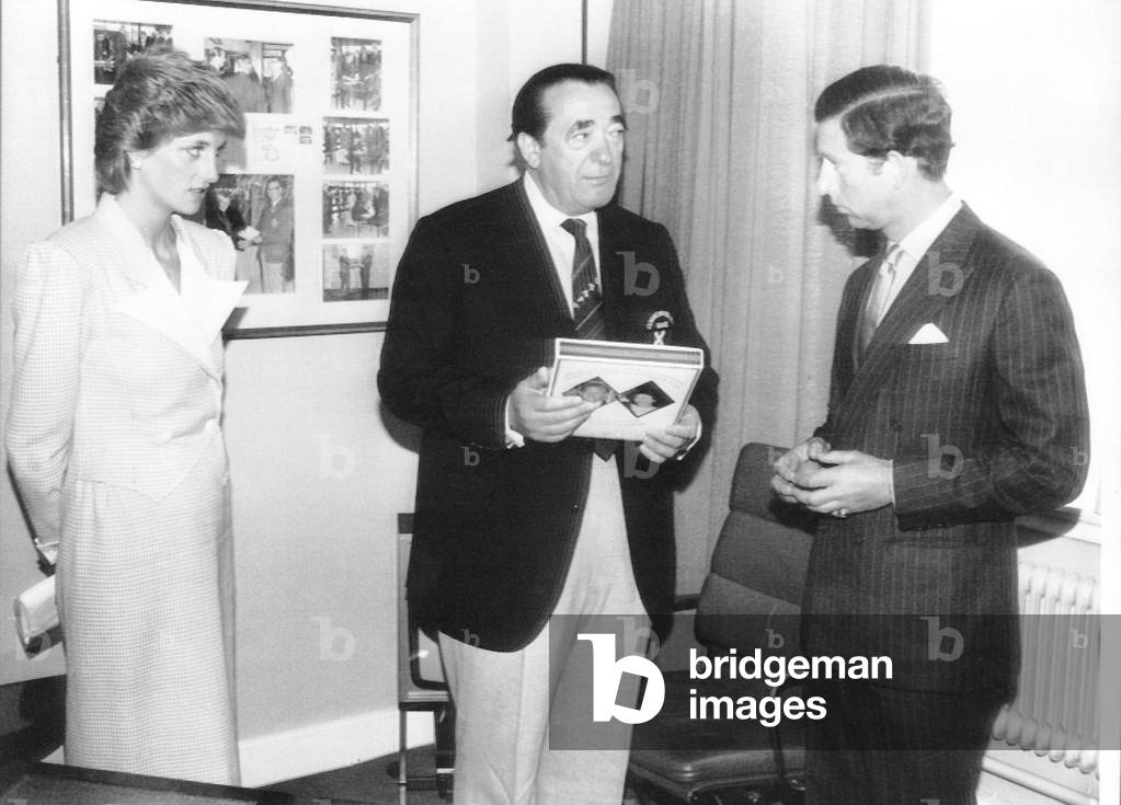 Robert Maxwell presenting Prince Charles with at gift Princess Diana watching at the Commonwealth games, 1986 (b/w photo)