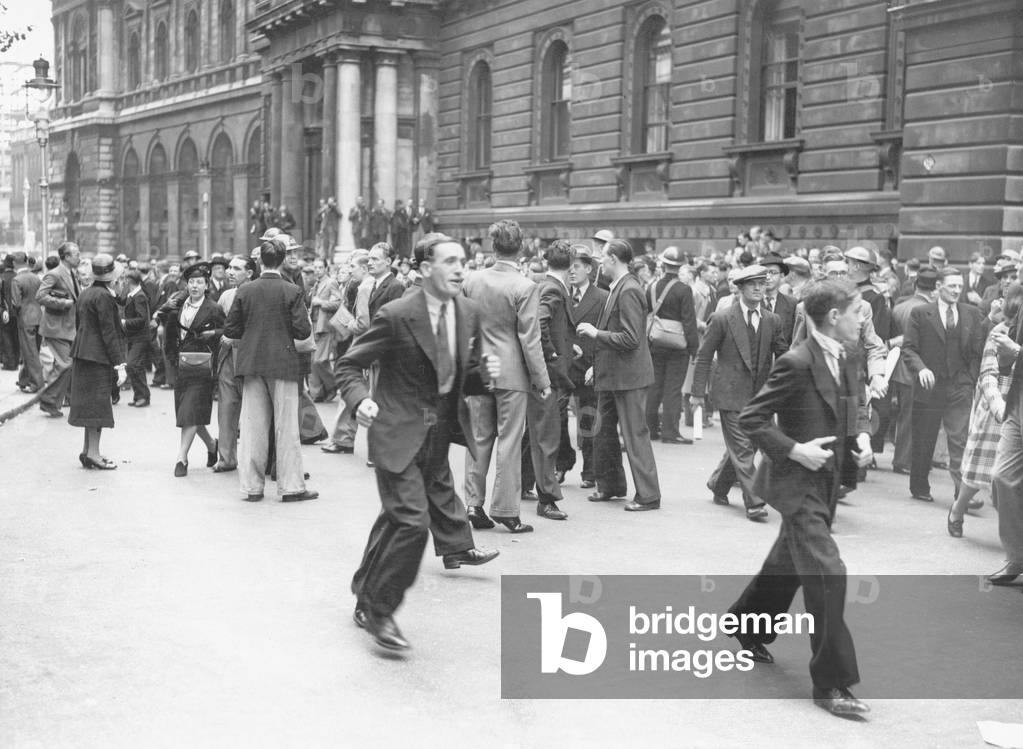 Crowds leaving Downing Street after an air raid warning. The crowd had gather to hear Prime Minister Neville Chamberlain announce Germany's failure to withdraw from Poland and that Britain had declared war on Germany, 3rd September 1939 (b/w photo)