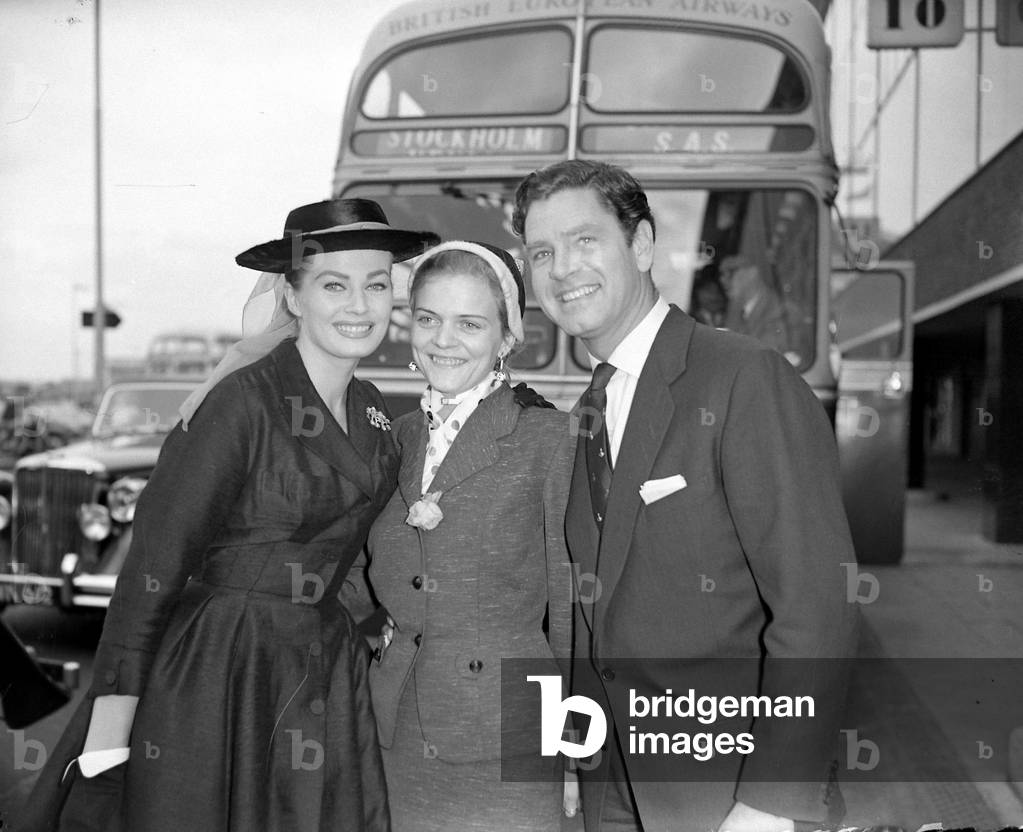 Actress Anita Ekberg left seen here with her husband Anthony Steel greeting her sister Inga centre, who is visiting Britain, 08/10/1956 (b/w photo)