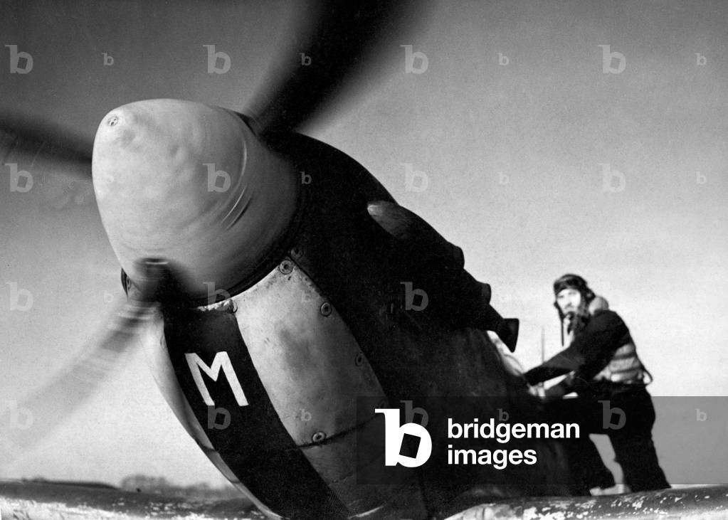 Sergeant S. W. Loader of New Barnet climbs into his Spitfire fighter plane to join a sweep over the English Channel during the Second World War, February 1944 (b/w photo)