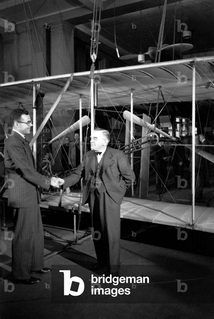 Wright Brothers 'Kitty Hawk' aeroplane, going back to U.S. from Science Museum, watched by A.V. Roe, Lord Tekenham and George Tomlinson. October 1948 O15203-003