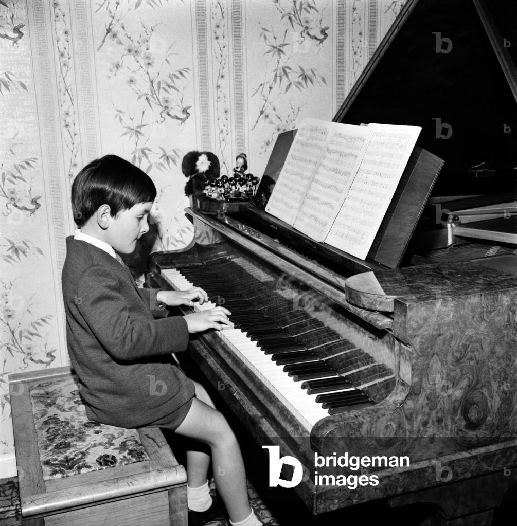 Seven year old boy playing songs on the piano which he has written himself. 
November 1969