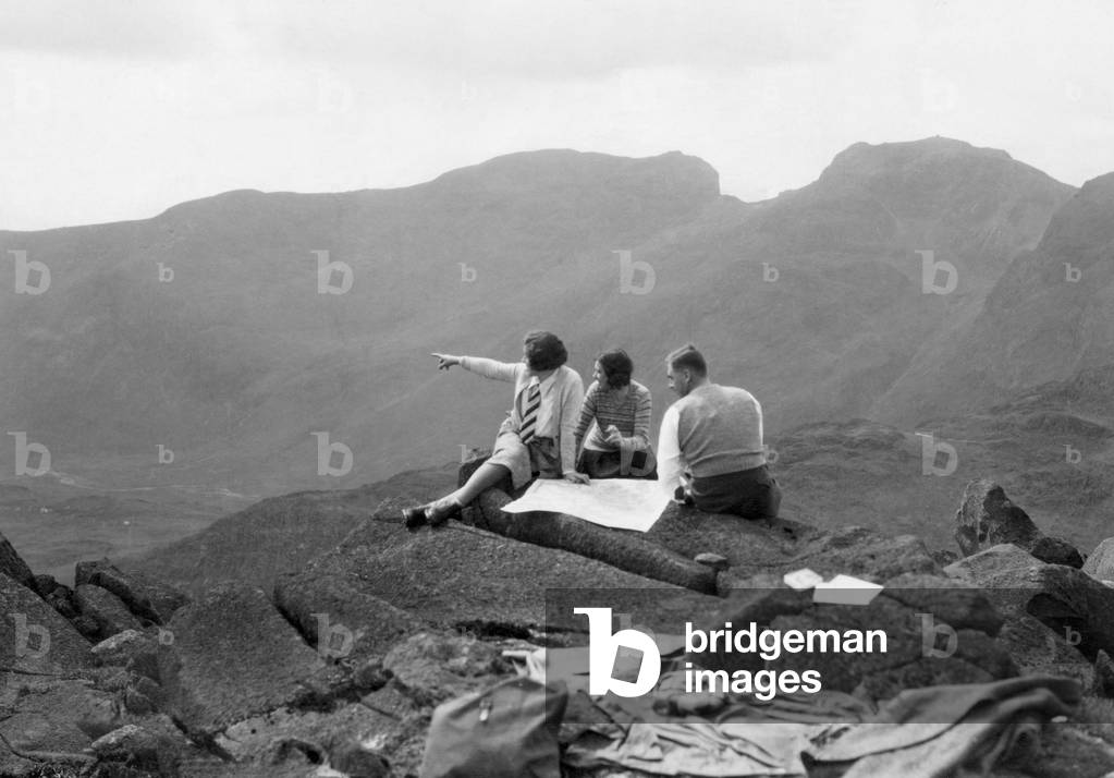 Lakeland hikers on top of Bowfell admire the grandeur of Scafell and Scafell Pike in the distance.
24th May 1931