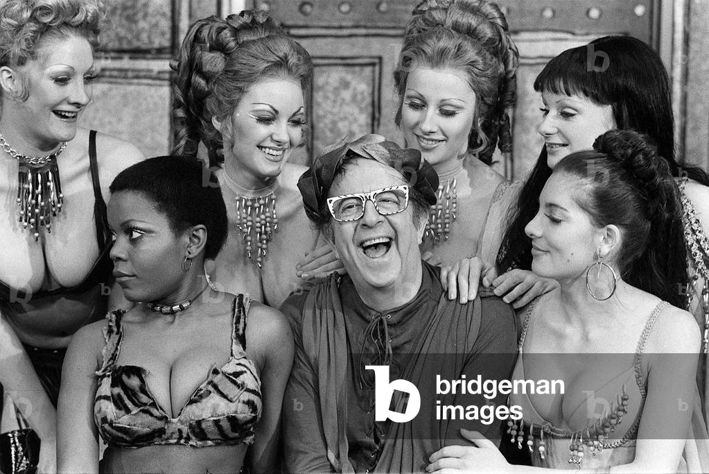 Phil Silvers the celebrated American actor and comedian seen with the sexy girls cast, January 1974 (b/w photo)