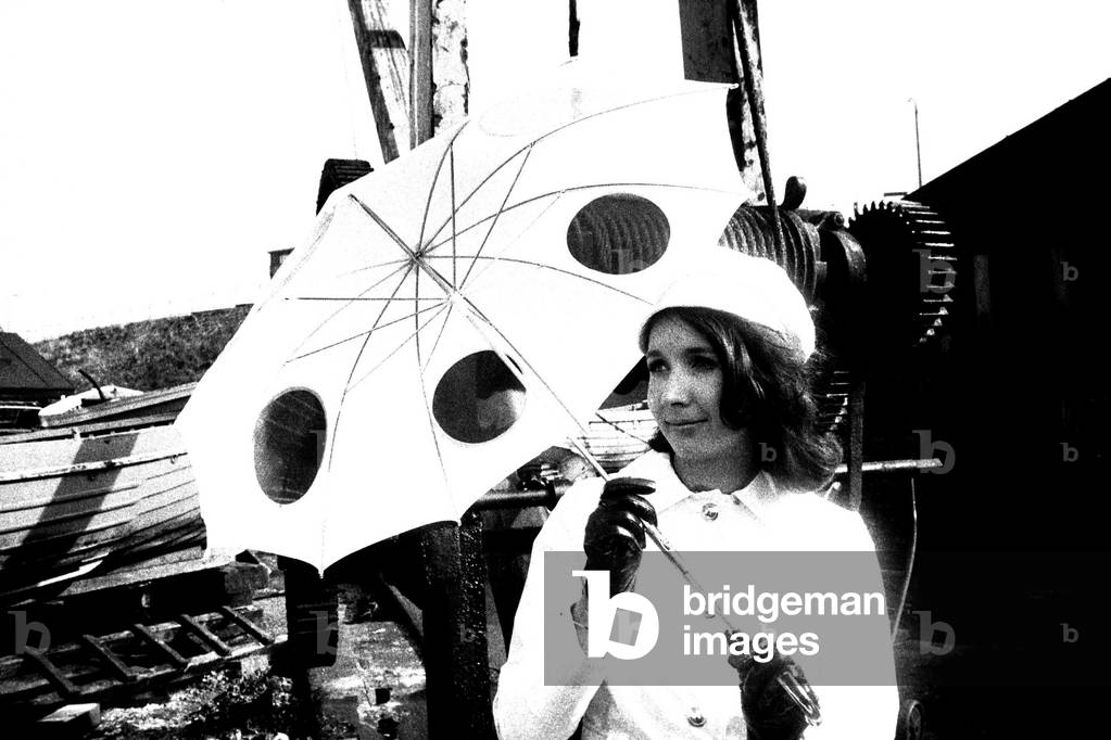A model posing with and umbrella, April 1970 (b/w photo)
