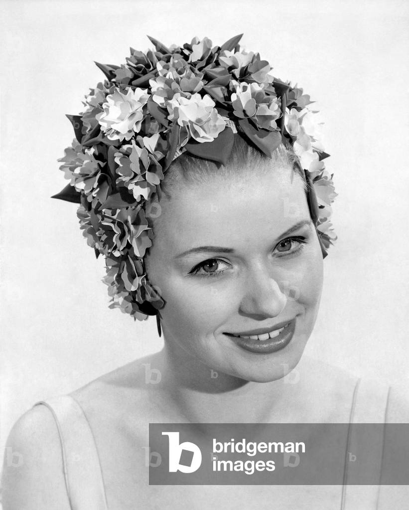 Clothing Beach: Garland Glory. A colourful cap with rich shades completely flower-decked. Price 5 Guineas. June 1965 P018012