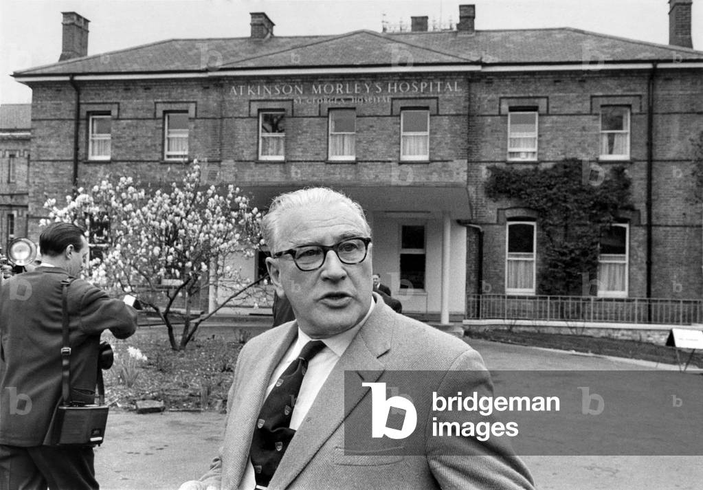 Stirling Moss in Atkinson Morley hospital, Wimbledon. Mr. Alfred Moss, Stirling Moss's father walks head bowed to see his son, still unconscious after his racing accident, April 1962 (b/w photo)