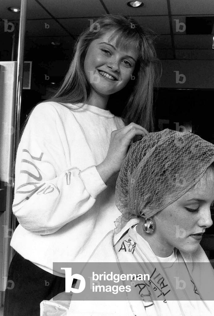 Danniella Westbrook actress in the BBC TV soap EastEnders seen here working at hairdressers on saturdays. March 1989 (b/w photo)