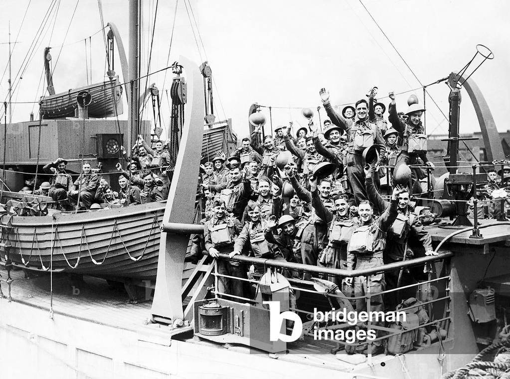 British Soldiers smiling and waving on board a troop ship as they sail to join the B.E.F. in France during WW2, 1940 (b/w photo)