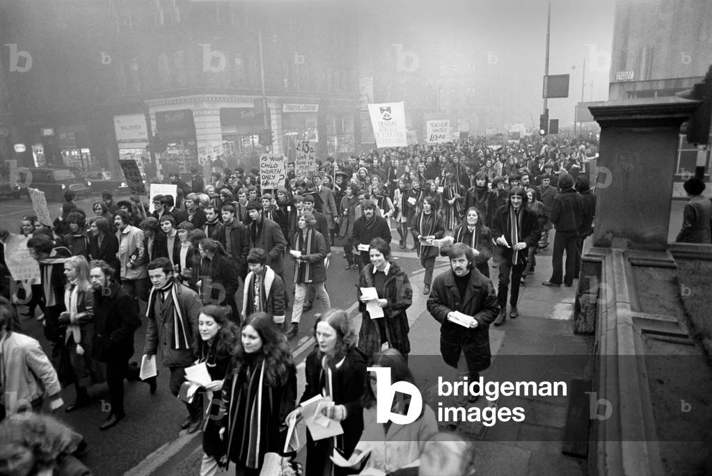 Students march to back teachers pay claim. Banner waving student outside the Department of Education in Crown Square